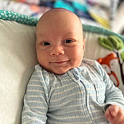 Lucas joined the competition — help win amazing prizes! baby, infant, smile, portrait, face, eyes, onesie, striped_clothing, bed, blanket, pillow, nursery, plush_toy, fox, bokeh, soft_light, skin, head, hand, closeup