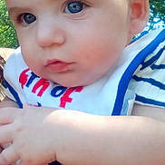 Robert is registered to the contest to win money with this photo: baby, infant, blue_eyes, bib, striped_clothing, outdoor, nature, portrait, closeup, child, cute, hand, skin, person, daylight, young, expression, human, face, summer