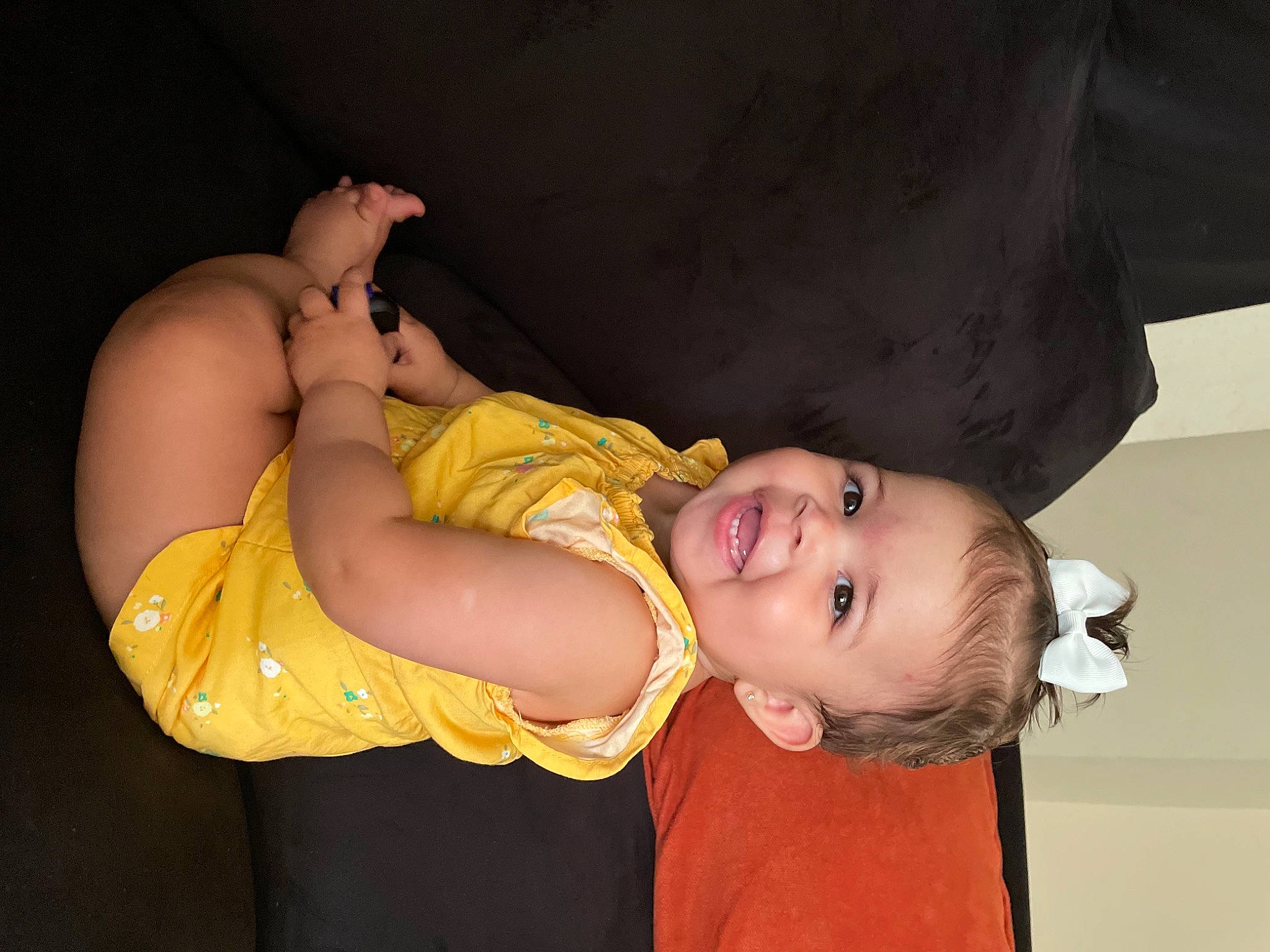 Adelina is registered to the contest to win money with this photo: abdomen, baby, baby_toddler_clothing, cheek, chest, comfort, couch, dress, elbow, flash_photography, happy, headgear, mouth, nose, person, shoulder, smile, stomach, thigh, toddler