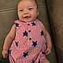 Sabrina joined the competition — help win amazing prizes! baby, infant, smile, face, earring, romper, striped_clothing, stars_pattern, couch, furniture, skin, happy, child, seated, indoor, cute, person, young_child, apparel, comfort