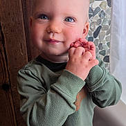 Oliver joined the competition — help win amazing prizes! toddler, child, blue_eyes, smiling, green_sweater, jeans, hands_clasped, indoor, wooden_wall, pebble_wall, portrait, cute, happy, person, standing, young_child, casual_clothing, close_up, baby_face, natural_light