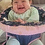 Celeste joined the competition — help win amazing prizes! baby, infant, smiling, happy, baby_seat, clothing, footwear, hair, indoors, curtain, fabric, pattern, child, cute, sitting, portrait, toddler, playful, face, expression