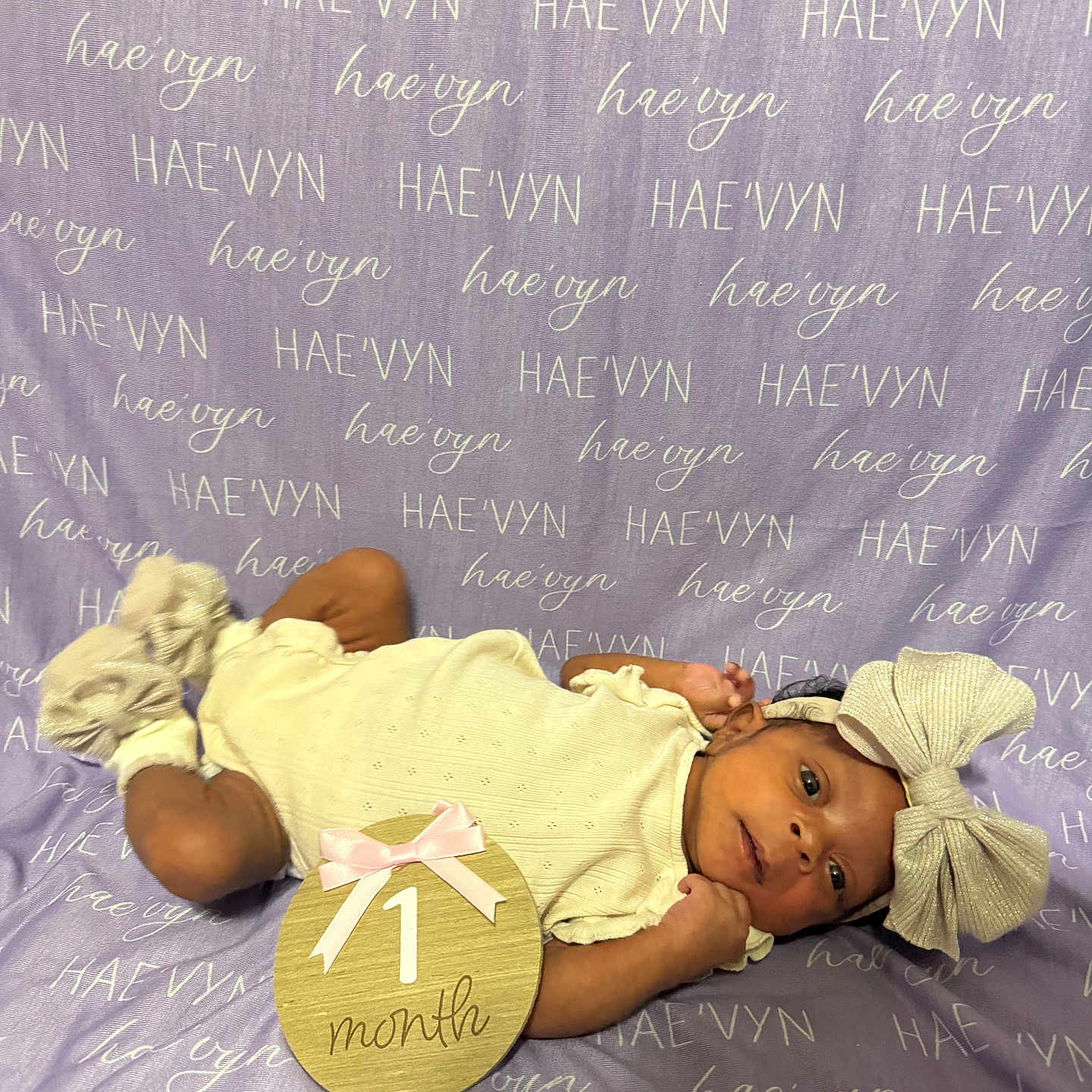 Haevyn joined the competition — help win amazing prizes! baby, blanket, bow, celebration, child, clothing, cute, fabric, footwear, headband, indoors, infant, lying_down, milestone, newborn, one_month_old, pink_bow, portrait, sign, soft_lighting