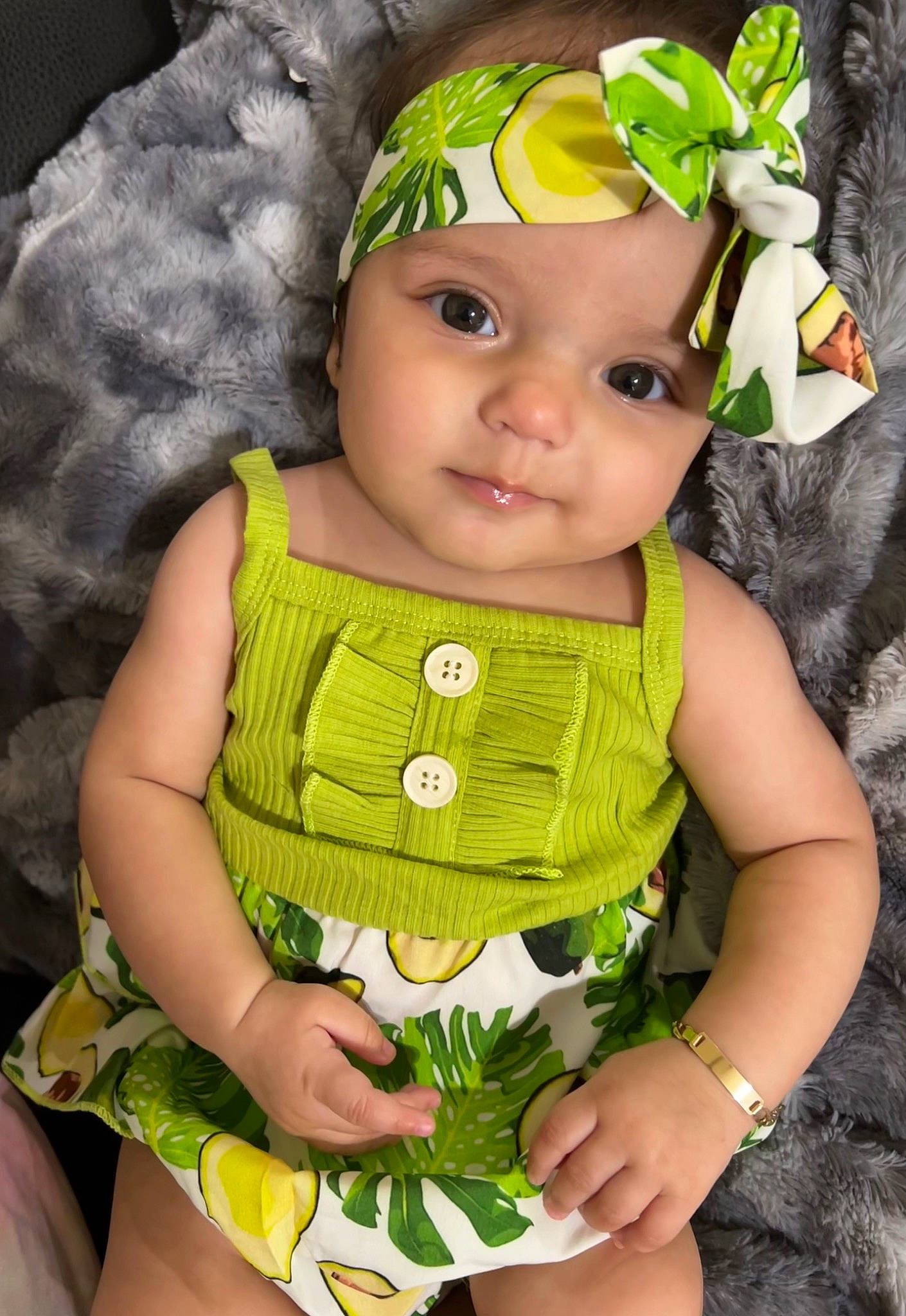 Hannah joined the competition — help win amazing prizes! baby, baby_products, baby_toddler_clothing, beanie, cap, cheek, child, costume_hat, eye, fashion_accessory, grass, green, happy, headwear, iris, knit_cap, pattern, person, sitting, skin