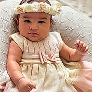 Olivia participe au concours pour gagner de l'argent avec cette photo : baby, infant, flower_headband, dress, pink, cream, cushion, knit_texture, portrait, cute, child, indoor, soft_lighting, small_hand, fashion, adorable, young, person, face, expression