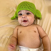 Lorenzo is registered to the contest to win money with this photo: baby, beanie, bodypart, bonnet, cap, clothing, diaper, face, finger, hand, happy, hat, head, newborn, person, photography, portrait, smile