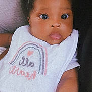 Kaliyah joined the competition — help win amazing prizes! baby, infant, bow, headband, bib, clothing, cute, face, child, portrait, closeup, skin, arm, eyes, expression, soft, cozy, indoor, person, adorable