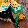 black_cat, cat, pet, animal, indoor, carpet, bag, plastic_bag, curious, eyes, hideout, cozy, feline, resting, playful, close_up, domestic_cat, household, texture, colorful
