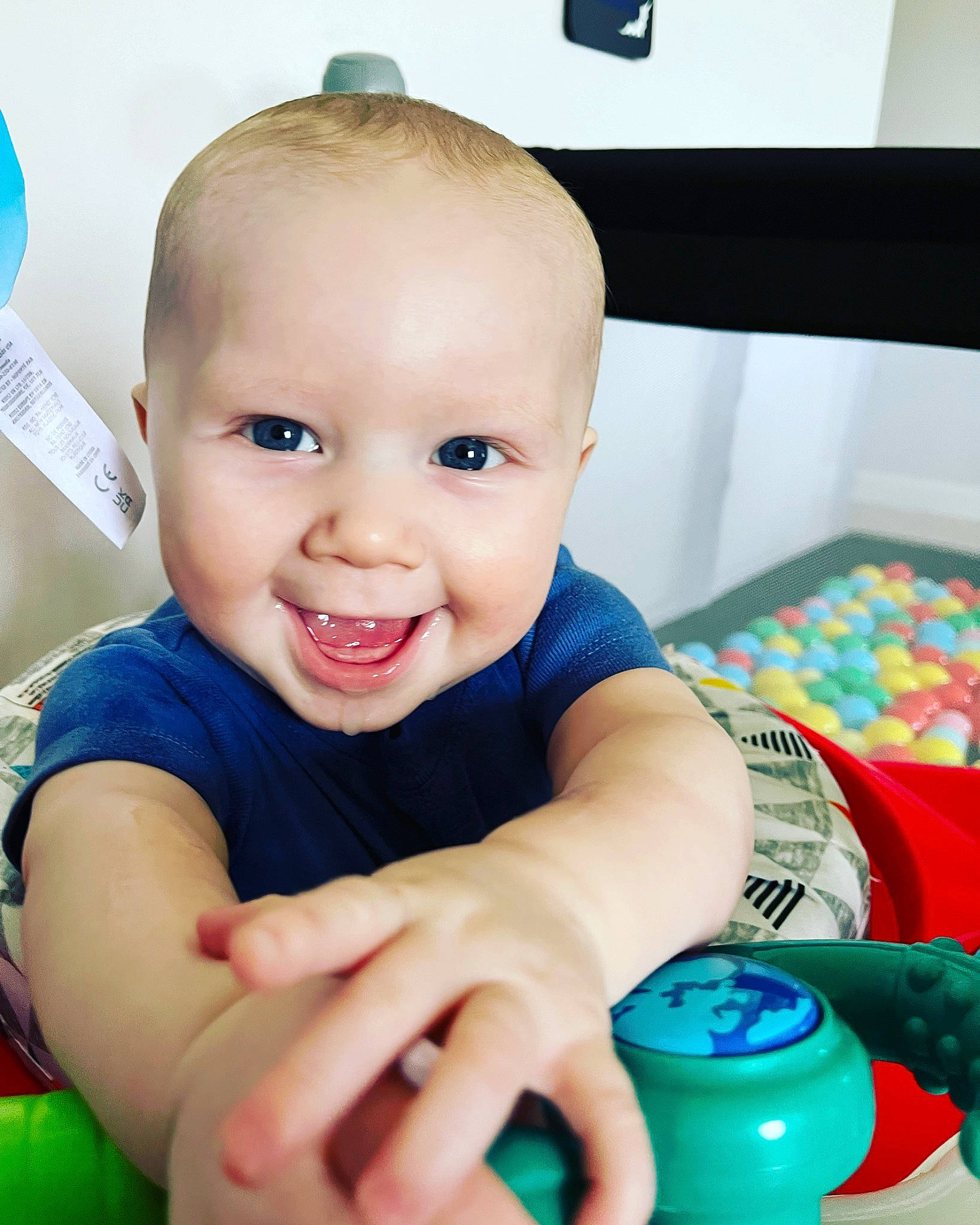 Joziah joined the competition — help win amazing prizes! baby, baby_playing_with_toys, blue, cheek, child, drinkware, eye, facial_expression, finger, fun, hand, happy, iris, joy, mouth, nose, person, plastic_bottle, skin, smile