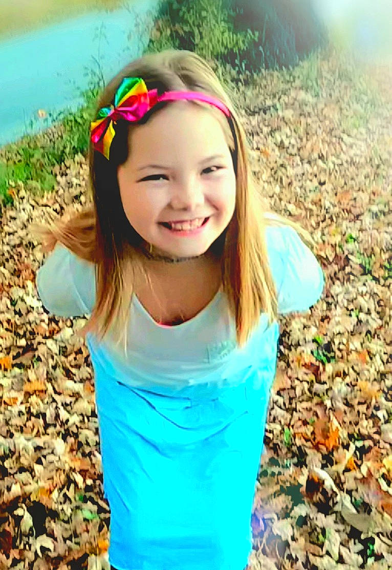 Rebecca is registered to the contest to win money with this photo: beauty, child, clothing, cool, fun, grass, green, hair, hairstyle, happy, head, joy, leaf, leisure, long_hair, people_in_nature, person, plant, recreation, smile