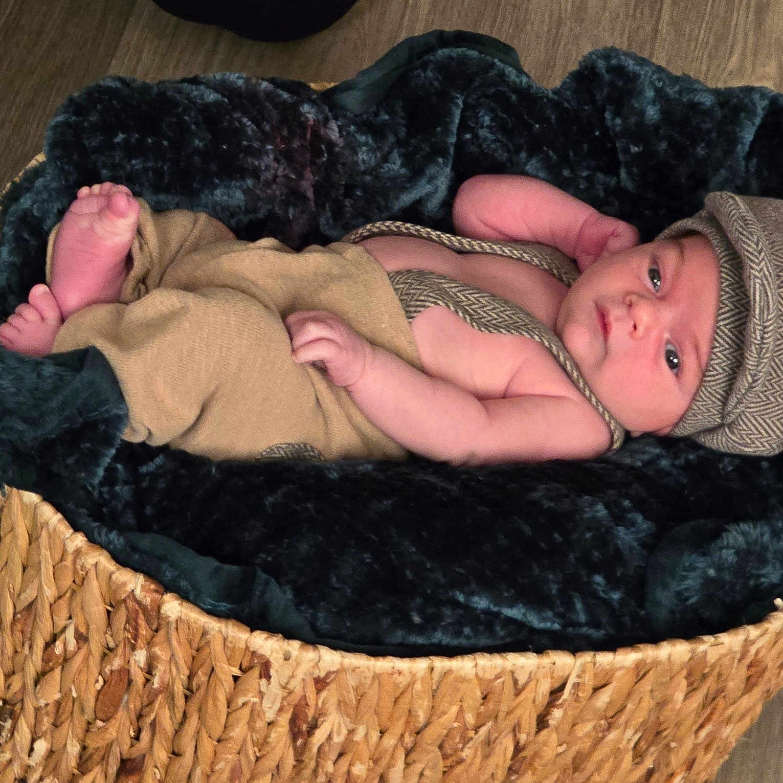 Brody joined the competition — help win amazing prizes! baby, baby_clothes, basket, blanket, child, clothing, cute, floor, hat, headwear, indoors, infant, laying, newborn, person, plush, portrait, resting, soft_texture, wooden_floor