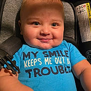 Charles is registered to the contest to win money with this photo: baby, smile, blue_onesie, car_seat, child, infant, happy, cute, drool, face, eyes, skin, hand, clothing, seatbelt, warning_label, indoor, portrait, person, cheeks