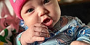 Saraiyah is registered to the contest to win money with this photo: baby, infant, child, pink_beanie, onesie, hand, face, eyes, expression, curious, cute, chubby_cheeks, indoor, soft_light, blurred_background, person, portrait, clothing, sitting, toddler