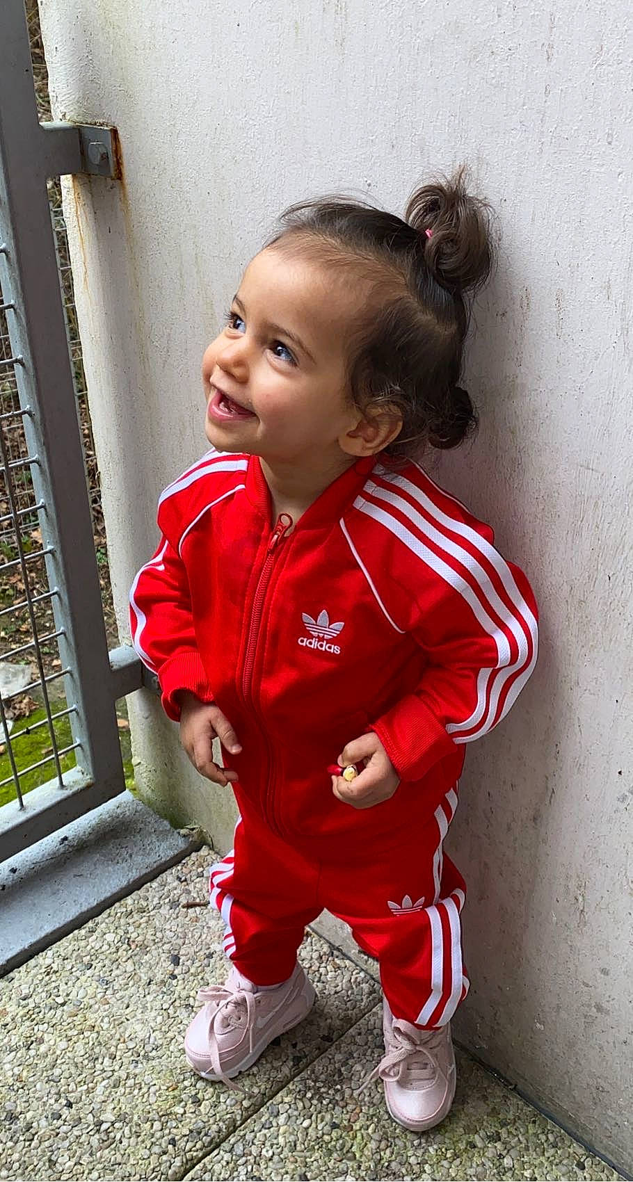 Liyah participe au concours pour gagner de l'argent avec cette photo : baby, baby_toddler_clothing, carmine, cheek, child, child_model, chin, hair, happy, jacket, pattern, person, plant, sitting, sleeve, smile, sneakers, sock, t_shirt, toddler
