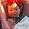 Kali is registered to the contest to win money with this photo: baby, red_bow, car_seat, blanket, child, infant, sunlight, seatbelt, pink, cute, smiling, indoors, clothing, pacifier, face, headwear, portrait, child_safety, happy, cozy