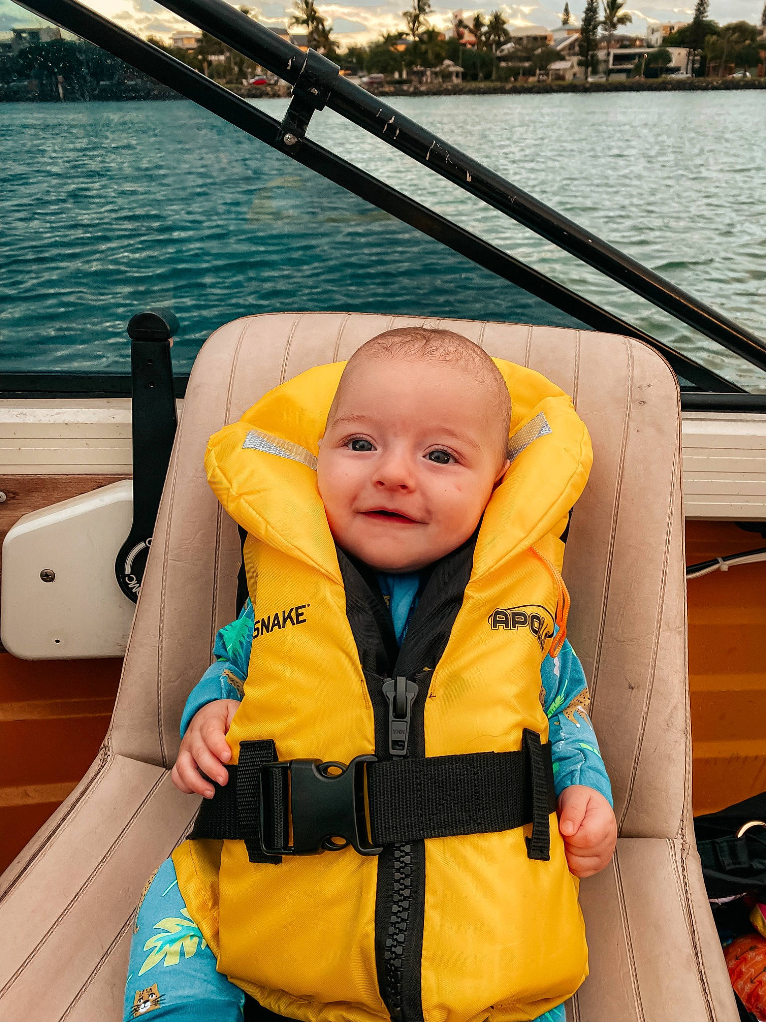 Jayden is registered to the contest to win money with this photo: baby_toddler_clothing, boat, boats_and_boating_equipment_and_supplies, body_of_water, comfort, eye, fun, lake, leisure, lifejacket, naval_architecture, person, photograph, recreation, smile, summer, toddler, travel, water, watercraft