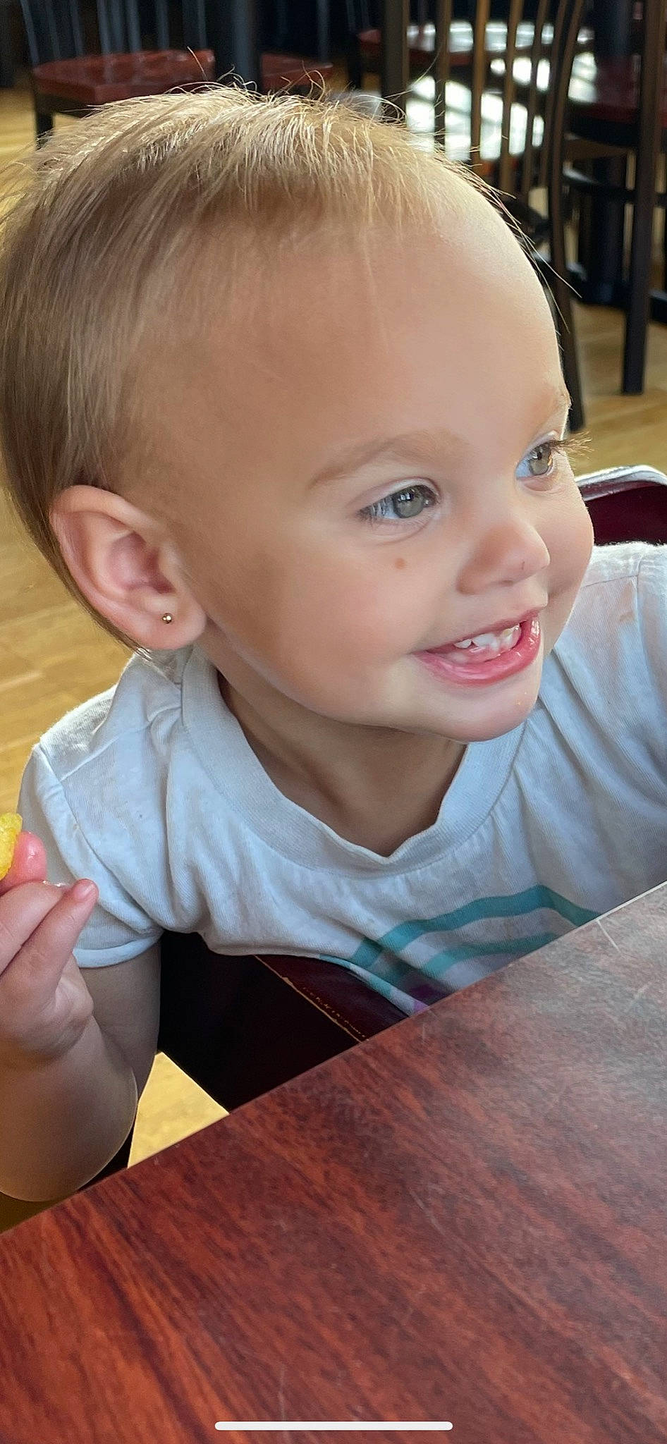 Ryder is registered to the contest to win money with this photo: baby_toddler_clothing, cheek, chin, ear, eyebrow, facial_expression, finger, flooring, fun, hand, happy, iris, lip, mouth, nose, person, skin, smile, table, toddler