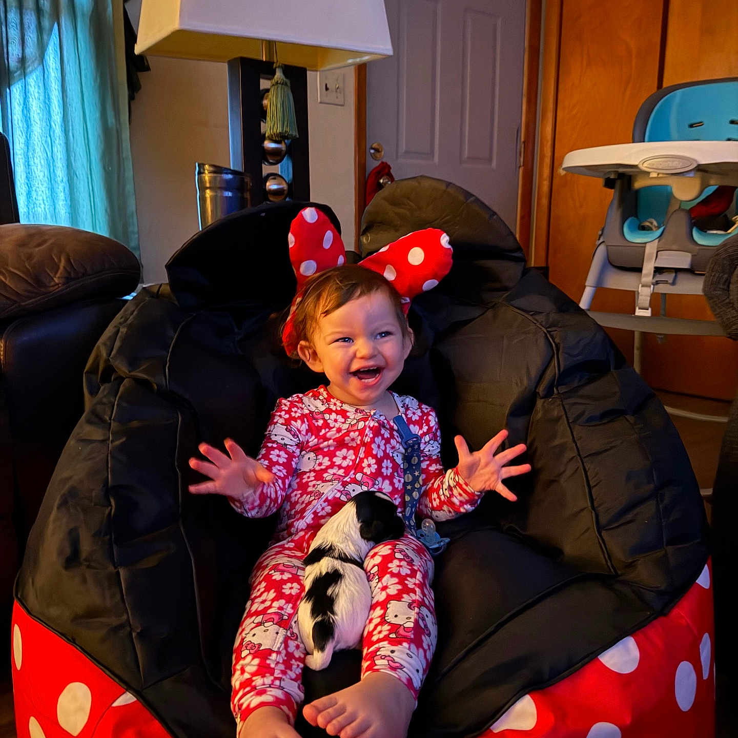 Blakely joined the competition — help win amazing prizes! child, toddler, smiling, pajamas, minnie_mouse_ears, bean_bag_chair, puppy, dog, indoor, lamp, door, high_chair, happy, feet, hand, person, furniture, curtain, home, cute