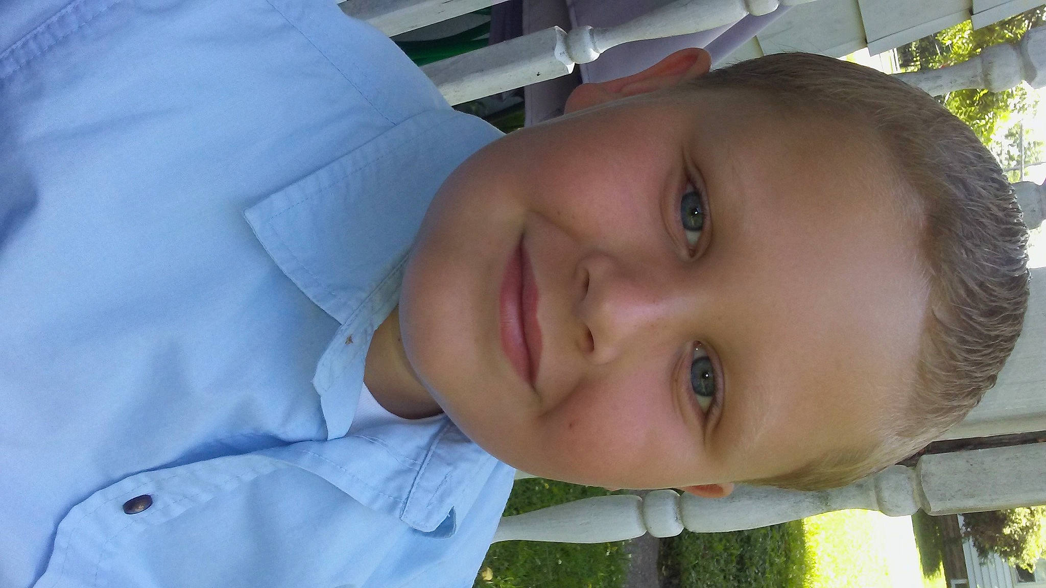 Julian is registered to the contest to win money with this photo: cheek, child, chin, eyebrow, eyelash, facial_expression, forehead, grass, happy, iris, jaw, joy, lip, mouth, neck, nose, person, plant, skin, smile