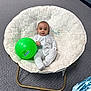 Elijah is registered to the contest to win money with this photo: baby, child, infant, plush_chair, green_ball, pajamas, carpet, indoor, office_chair, door, footwear, person, seated, toy, face, head, legs, hands, relaxed, casual
