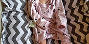 Cassi is registered to the contest to win money with this photo: baby, sleeping, infant, onesie, pink_clothing, polka_dot, socks, frills, blanket, chevron_pattern, bassinet, mesh_sides, pacifier, soft_lighting, indoor, cute, peaceful, resting, child, portrait