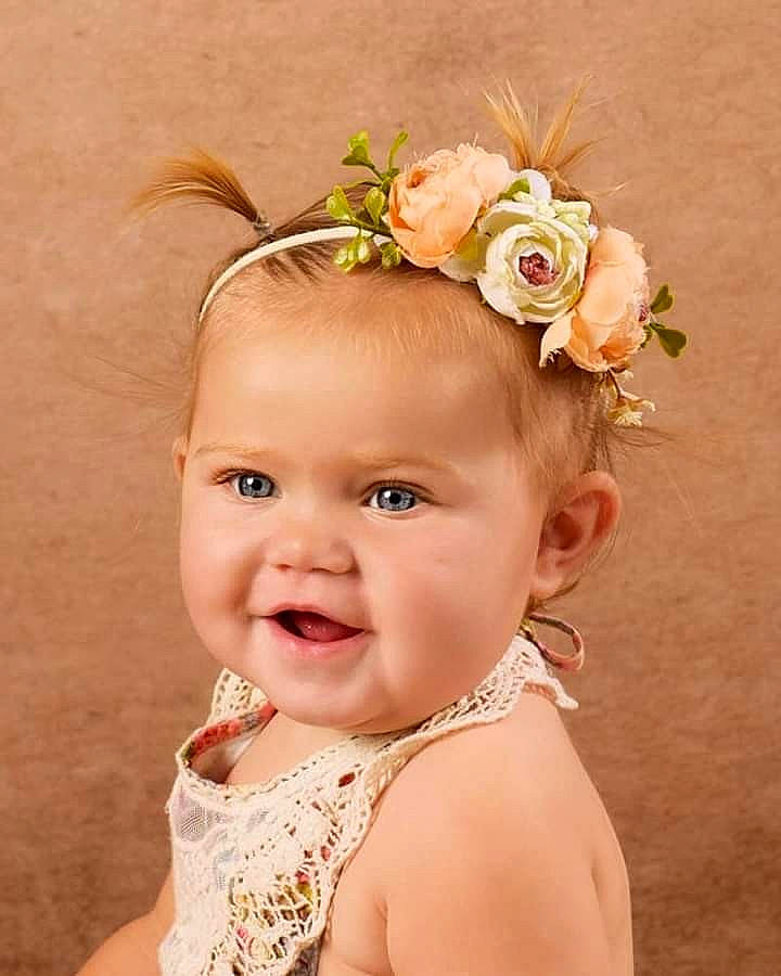 Carly joined the competition — help win amazing prizes! baby, cheek, child, child_model, crown, fashion_accessory, flower, hair_accessory, head, headband, headgear, headpiece, person, plant, smile, toddler