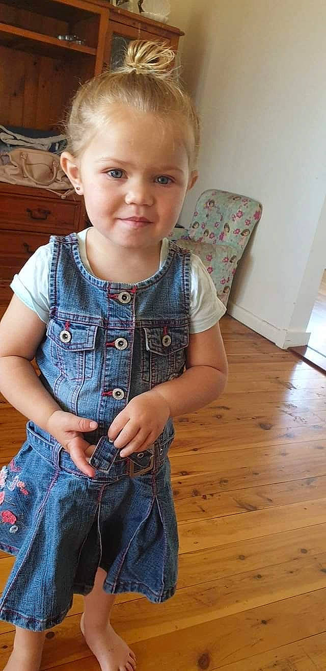Carly is registered to the contest to win money with this photo: blond, child, child_model, denim, floor, flooring, jeans, joy, person, play, sitting, sleeve, standing, textile, toddler