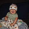 Courage joined the competition — help win amazing prizes! apparel, baby, blanket, child, child_infant, clothing, cozy, cute, football_pattern, happy, hat, indoor, infant, infant_clothing, joyful, person, portrait, sitting, smiling, tongue_out