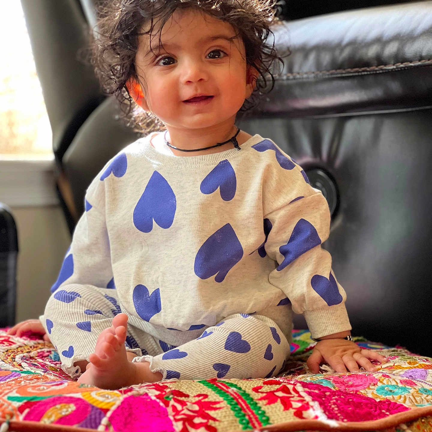 Aarna is registered to the contest to win money with this photo: accessories, baby, bodypart, clothing, couch, cushion, face, finger, furniture, hair, hand, head, homedecor, hosiery, jewelry, necklace, person, photography, portrait, sitting