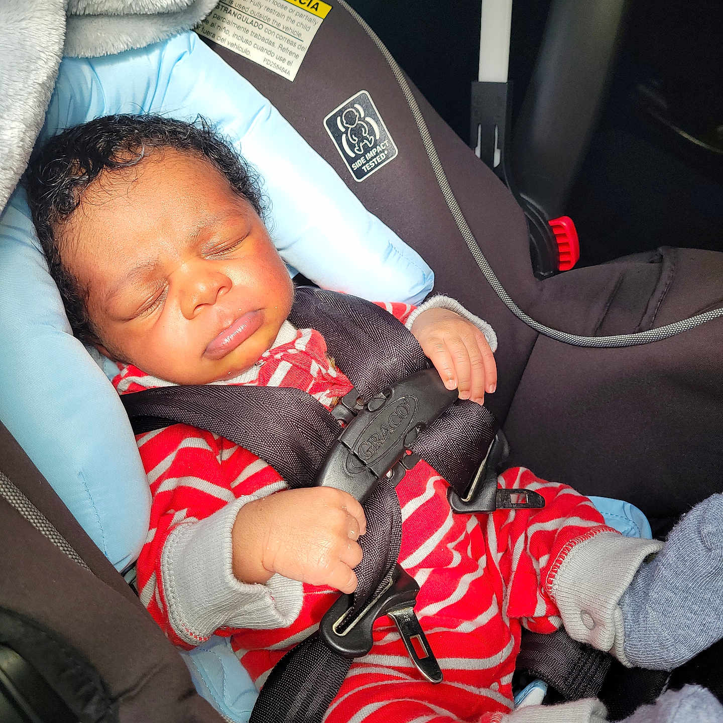 Aeson joined the competition — help win amazing prizes! baby, car_interior, car_seat, child, clothing, comfort, cute, face, footwear, hand, head, infant, person, rest, safety_harness, seat_belt, sleeping, sock, stripes, transportation