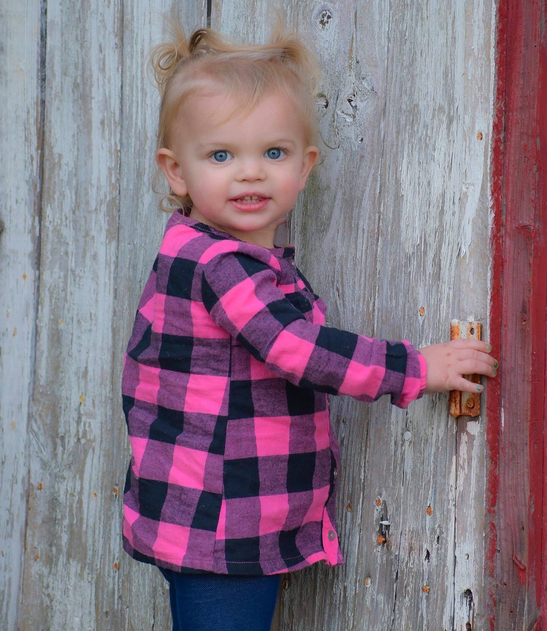 Alaina is registered to the contest to win money with this photo: arm, baby_toddler_clothing, dress_shirt, face, gesture, happy, human_body, jeans, magenta, person, pink, plaid, plant, purple, sleeve, smile, standing, tartan, tree, waist