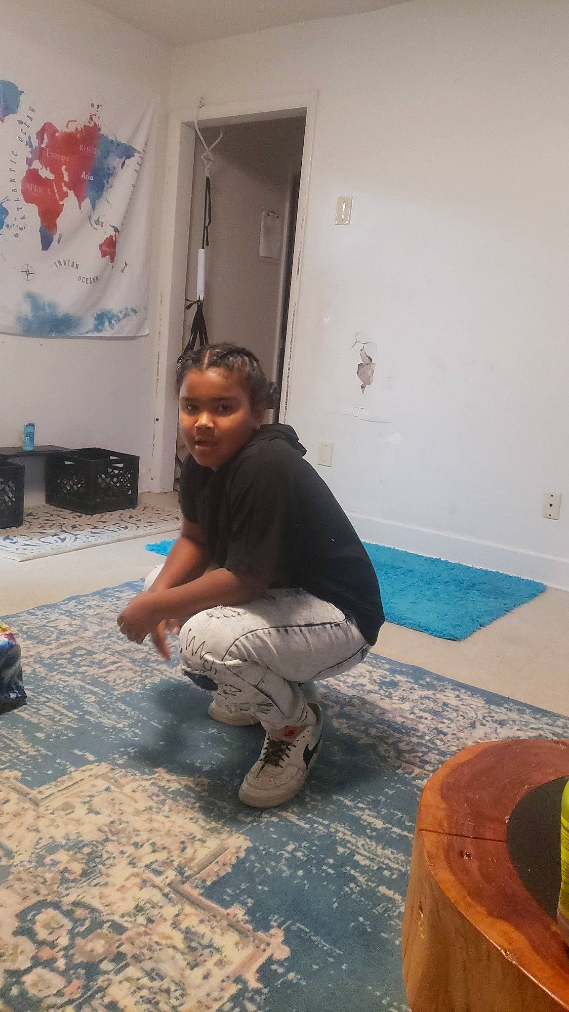 Carter is registered to the contest to win money with this photo: barefoot, boot, comfort, concrete, door, floor, flooring, foot, fun, hardwood, human_leg, knee, leg, leisure, person, plaster, room, shorts, sitting, tile