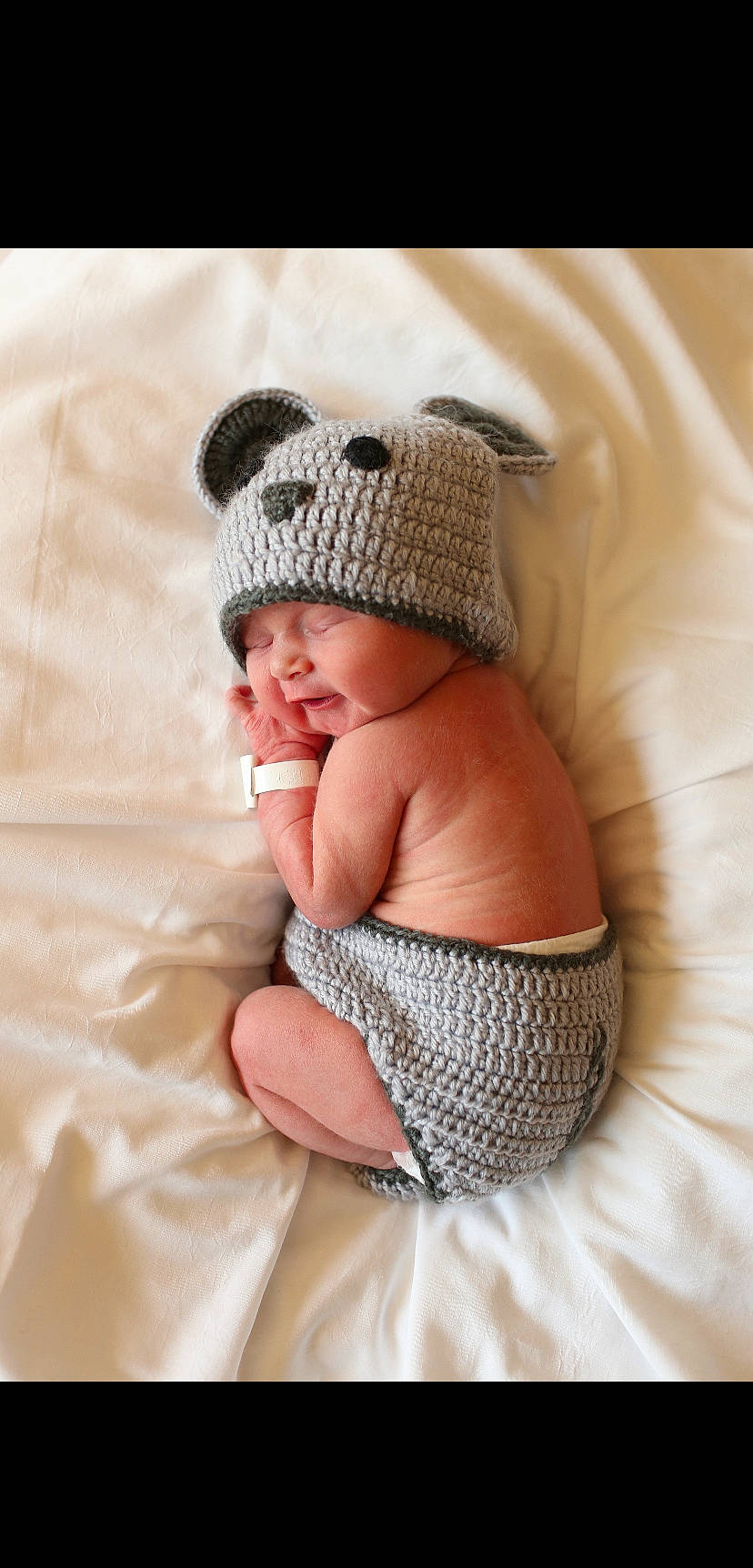 Joziah is registered to the contest to win money with this photo: baby, baby_products, baby_sleeping, baby_toddler_clothing, cap, comfort, crochet, fashion_accessory, fur, headgear, headwear, knit_cap, linens, pattern, person, sitting, sleeve, smile, textile, toddler