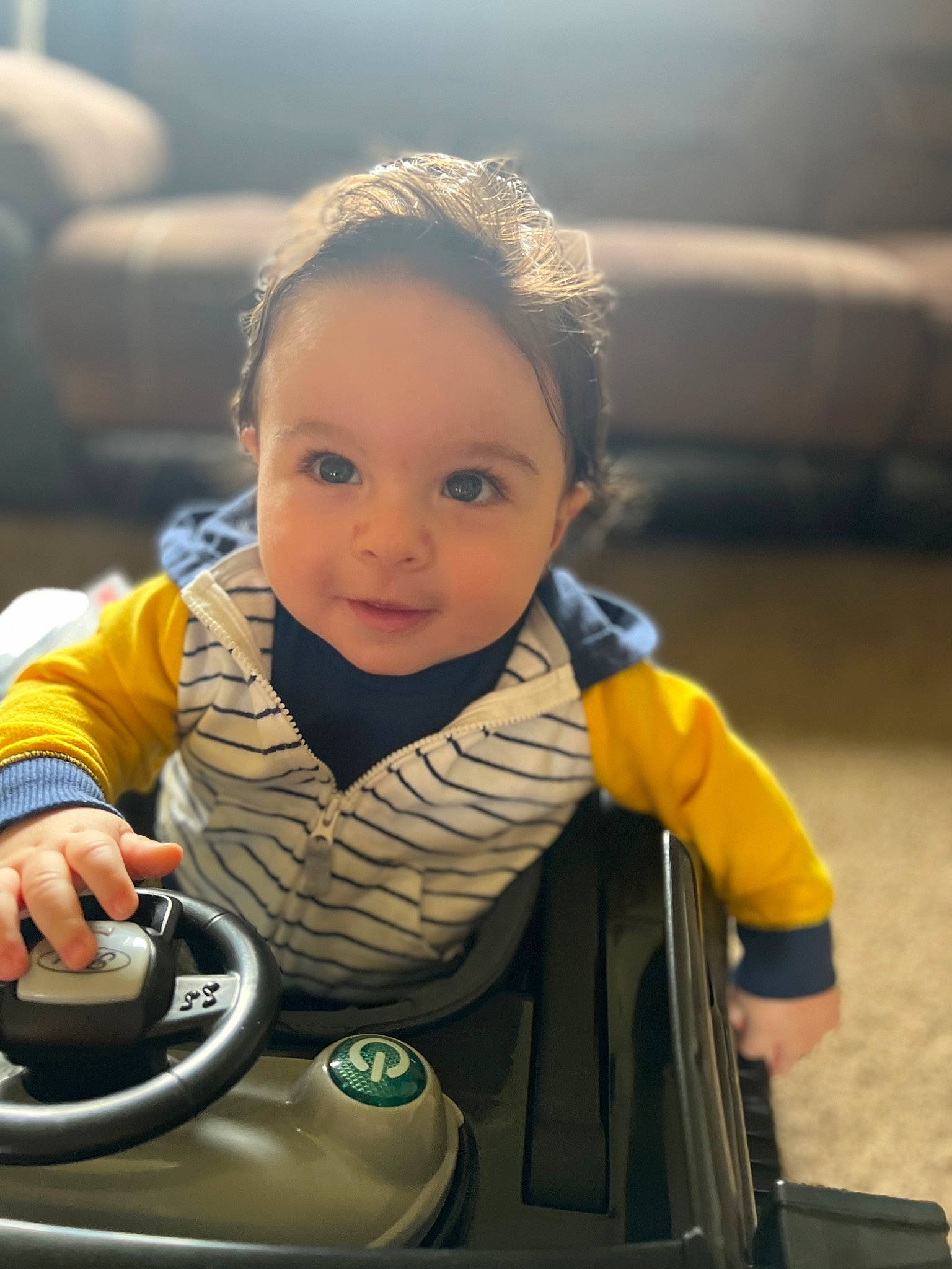 Jimmy is registered to the contest to win money with this photo: audio_equipment, automotive_design, automotive_tire, child, eye, face, fun, happy, leisure, motor_vehicle, person, photograph, recreation, sitting, skin, snapshot, steering_wheel, tire, toddler, travel