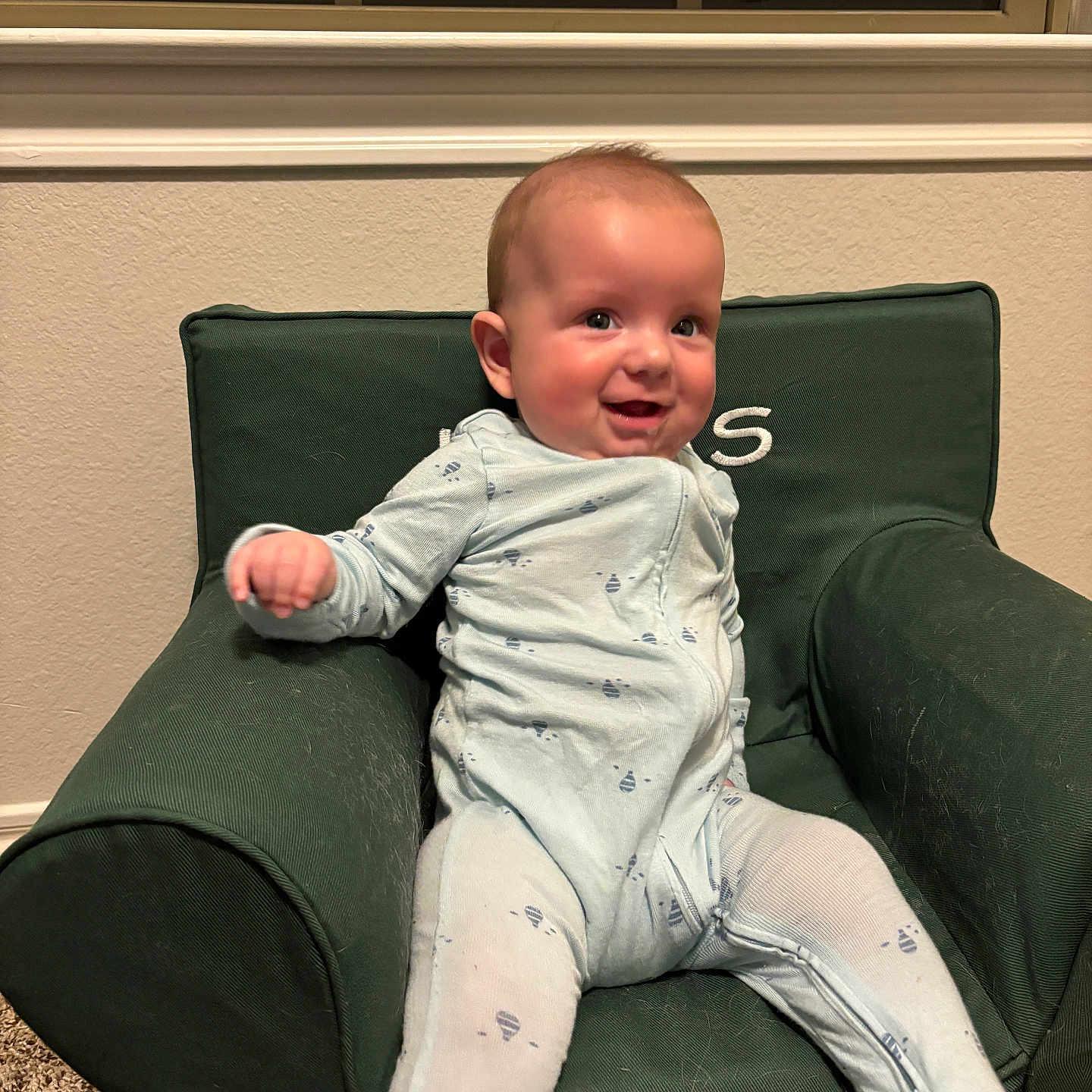 Lucas is registered to the contest to win money with this photo: armchair, baby, bodypart, chair, clothing, couch, cushion, face, finger, furniture, hand, happy, head, homedecor, pants, person, photography, portrait, sitting, smile