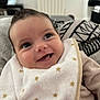 baby, bib, blanket, child, closeup, clothing, cozy, cute, expression, face, happy, indoor, infant, person, portrait, smile, soft, star_pattern, warm, young