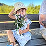 arm, bench, blue_eyes, casual, child, cute, dress, flowers, footwear, hat, nature, outdoor, person, portrait, sitting, striped_dress, summer, sunny, tattoo, wildflowers
