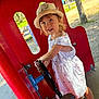 Ambre a rejoint le concours — aidez-le/la à gagner de superbes lots ! child, daylight, dress, fun, grass, happy, hat, outdoor, park, person, play, playground, red_structure, shoes, smile, steering_wheel, summer, sunlight, toddler, trees