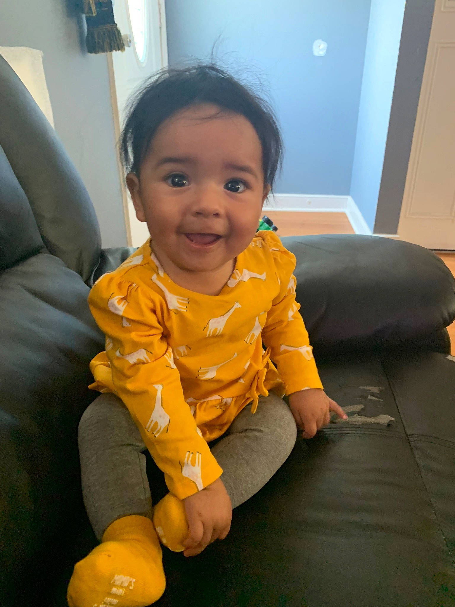 Becky is registered to the contest to win money with this photo: baby, child, face, head, person, play, sitting, skin, smile, toddler, yellow