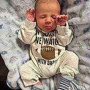 Jaxson joined the competition — help win amazing prizes! baby, newborn, sleeping, infant, blanket, clothing, socks, chain, football, pattern, cute, hands_up, soft, cozy, portrait, indoors, child, apparel, resting, peaceful