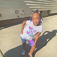 Dior is registered to the contest to win money with this photo: child, city, clothing, face, female, footwear, girl, head, path, person, photography, portrait, road, shoe, shorts, sneaker, street, summer, t_shirt, urban