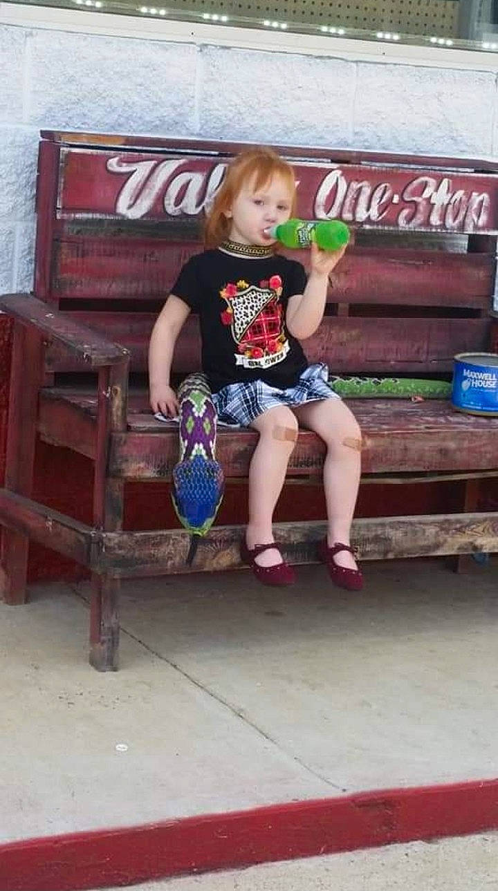 Talia is registered to the contest to win money with this photo: child, city, foot, fun, human_leg, knee, leg, leisure, magenta, person, pink, recreation, shorts, sitting, soil, street_fashion, t_shirt, thigh, toddler, vacation