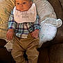 Kace Ray Lewis joined the competition — help win amazing prizes! baby, infant, child, plaid_shirt, bib, pants, shoes, couch, pillow, fabric, pattern, text, be_brave, little_man, indoor, person, seated, cute, young, casual_clothing