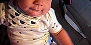Kace Ray Lewis is registered to the contest to win money with this photo: baby, child, infant, onesie, star_pattern, tissue, car_seat, can, seatbelt, hand, foot, face, expression, curious, indoor, vehicle, clothing, person, sitting, young