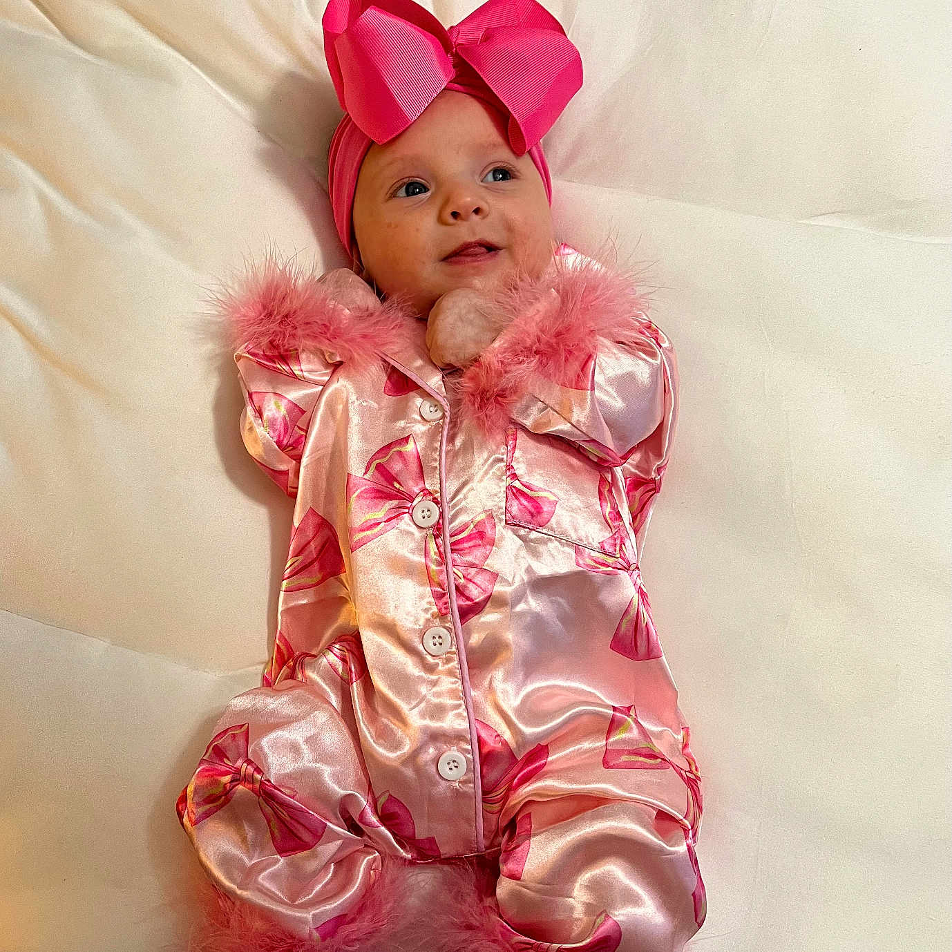 Adalyn joined the competition — help win amazing prizes! baby, child, clothing, cozy, cute, fabric, face, feet, fluffy_trim, happy, headband, indoor, infant, lying_down, one_person, pink_bow, pink_outfit, portrait, smiling, soft_surface