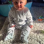 Lucas joined the competition — help win amazing prizes! baby, child, infant, smile, carpet, playpen, toy, indoor, blond_hair, blue_eyes, onesie, sitting, sunlight, shadow, cute, happy, floor, room, toddler, clothing