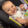 baby, car_seat, smile, child, infant, bib, toy, happy, indoor, seat, clothing, person, cute, face, expression, young_child, sitting, bright, playful, comfort