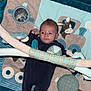 baby, infant, play_mat, soft_toys, plush, child, blue, beige, toy_arch, clothing, lying_down, face, head, person, cute, indoor, floor, comfort, baby_gym, infant_play