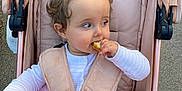 Lottie is registered to the contest to win money with this photo: baby, baby_clothes, blanket, candid, child, clothing, comfort, curly_hair, cute, infant, outdoor, pacifier, person, pink, seat, seatbelt, snack, stroller, toddler, toy