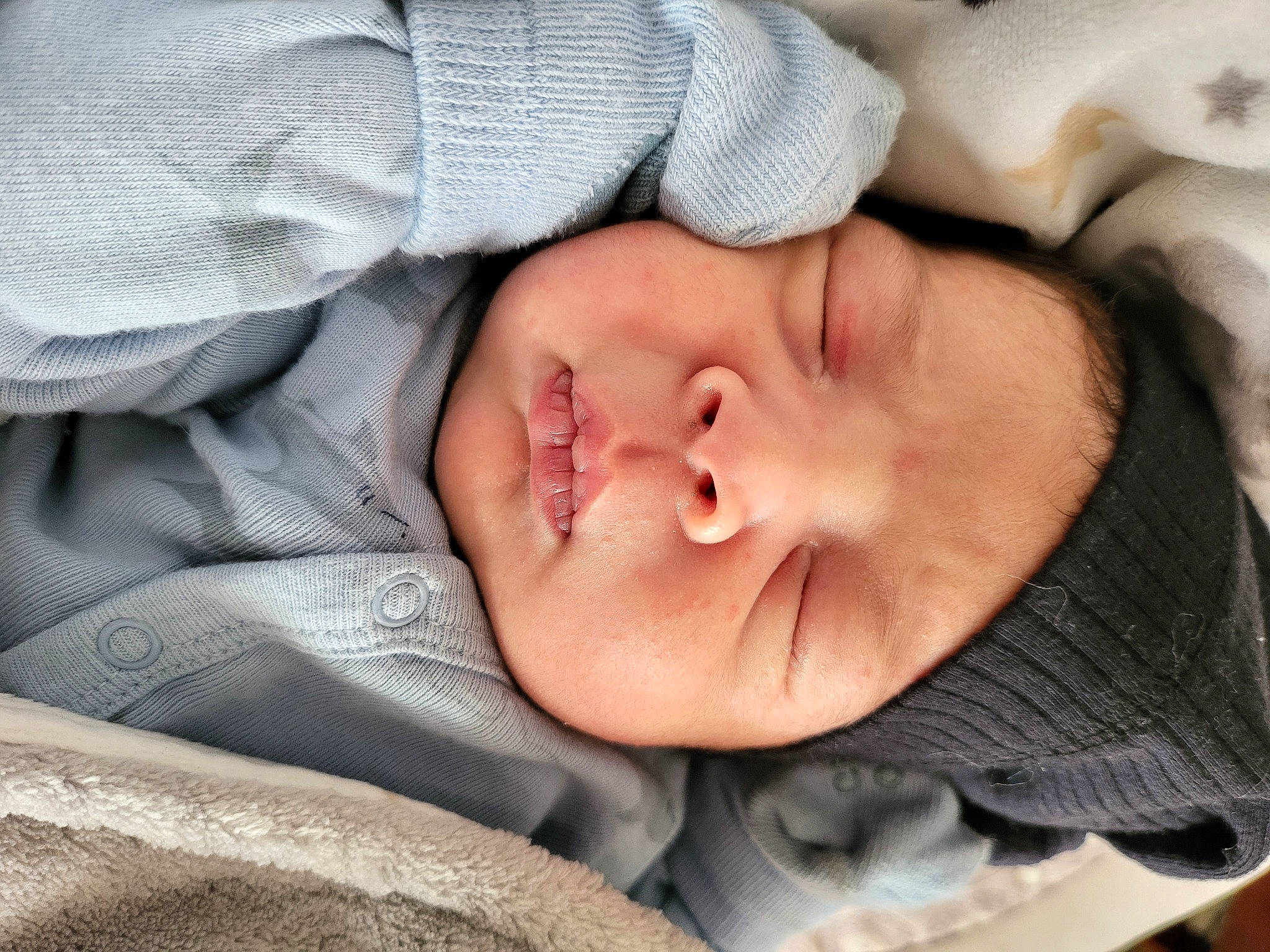 Manuel is registered to the contest to win money with this photo: baby, baby_products, baby_toddler_clothing, bedtime, cheek, child, close_up, comfort, eye, eyelash, happy, iris, linens, lip, nap, nose, person, portrait_photography, skin, textile